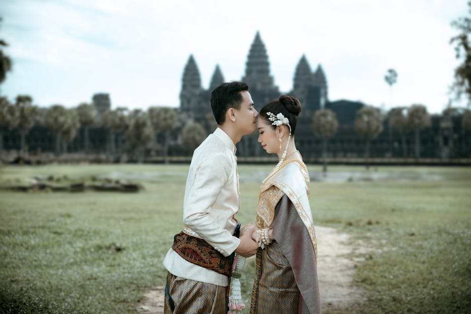 MyReadignamga A couple in traditional Cambodian attire embracing at Angkor Wat, a symbol of timeless love.