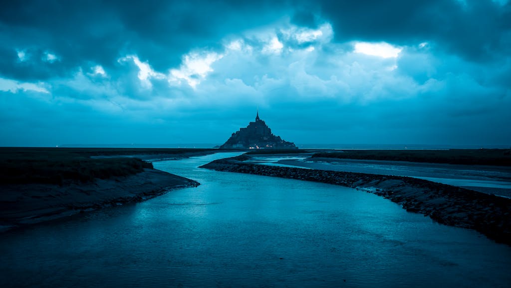 Monika Leveski A moody, twilight view of Mont Saint-Michel with dramatic clouds.