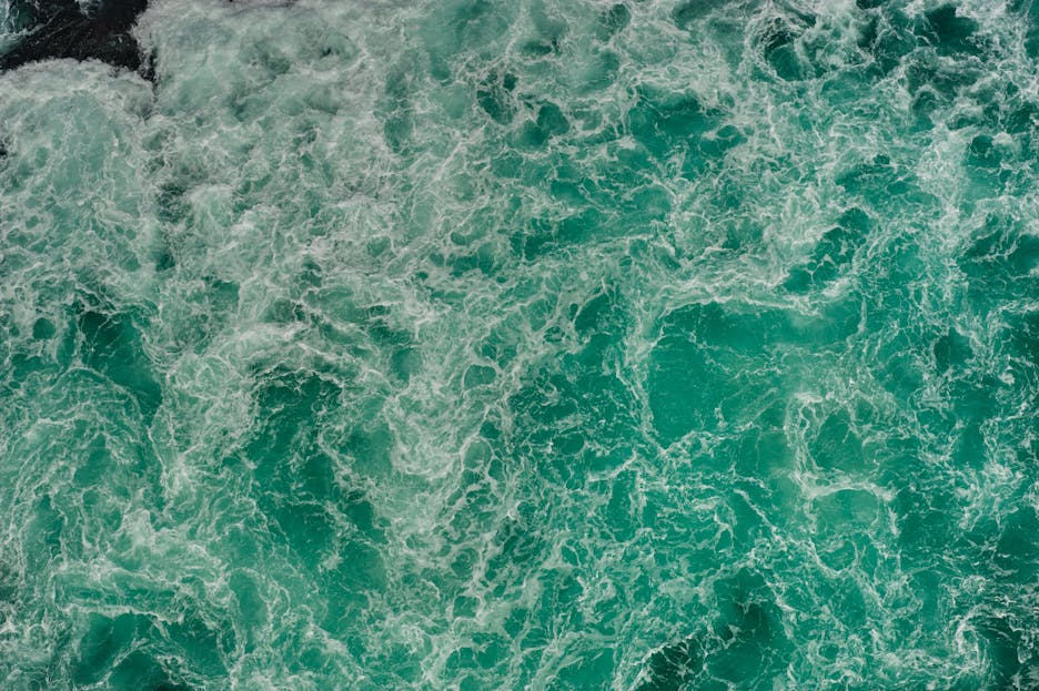 Naruto Senki Aerial shot of swirling turquoise waters in Naruto, Tokushima, Japan, capturing nature's power.