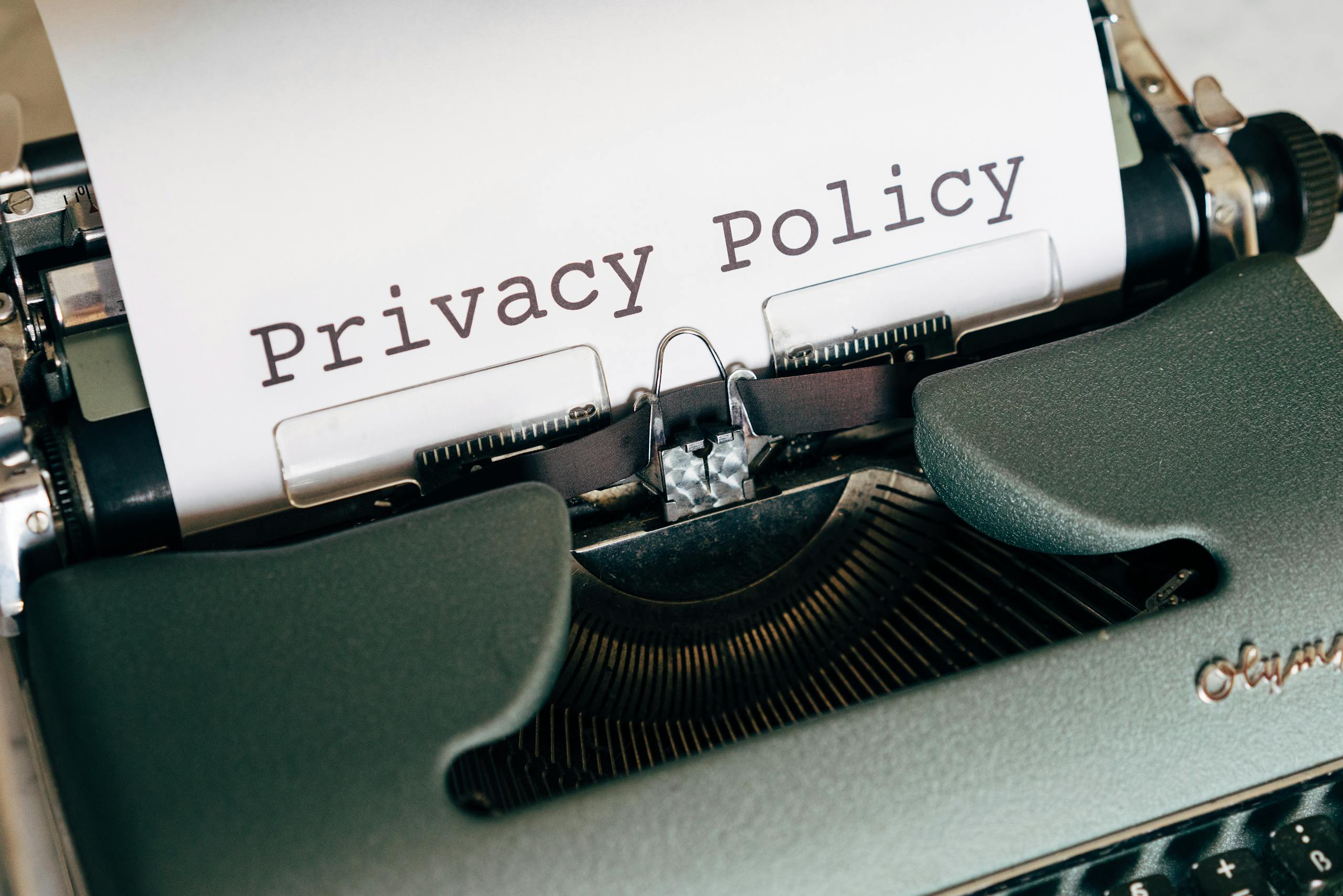 Privacy Policy Gonzay.com Close-up of a vintage typewriter featuring a privacy policy document in focus, highlighting classic technology.