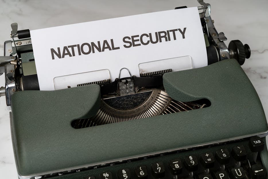 Privacy Policy Gonzay.com Close-up of a vintage typewriter with a paper marked 'National Security', symbolizing confidentiality.