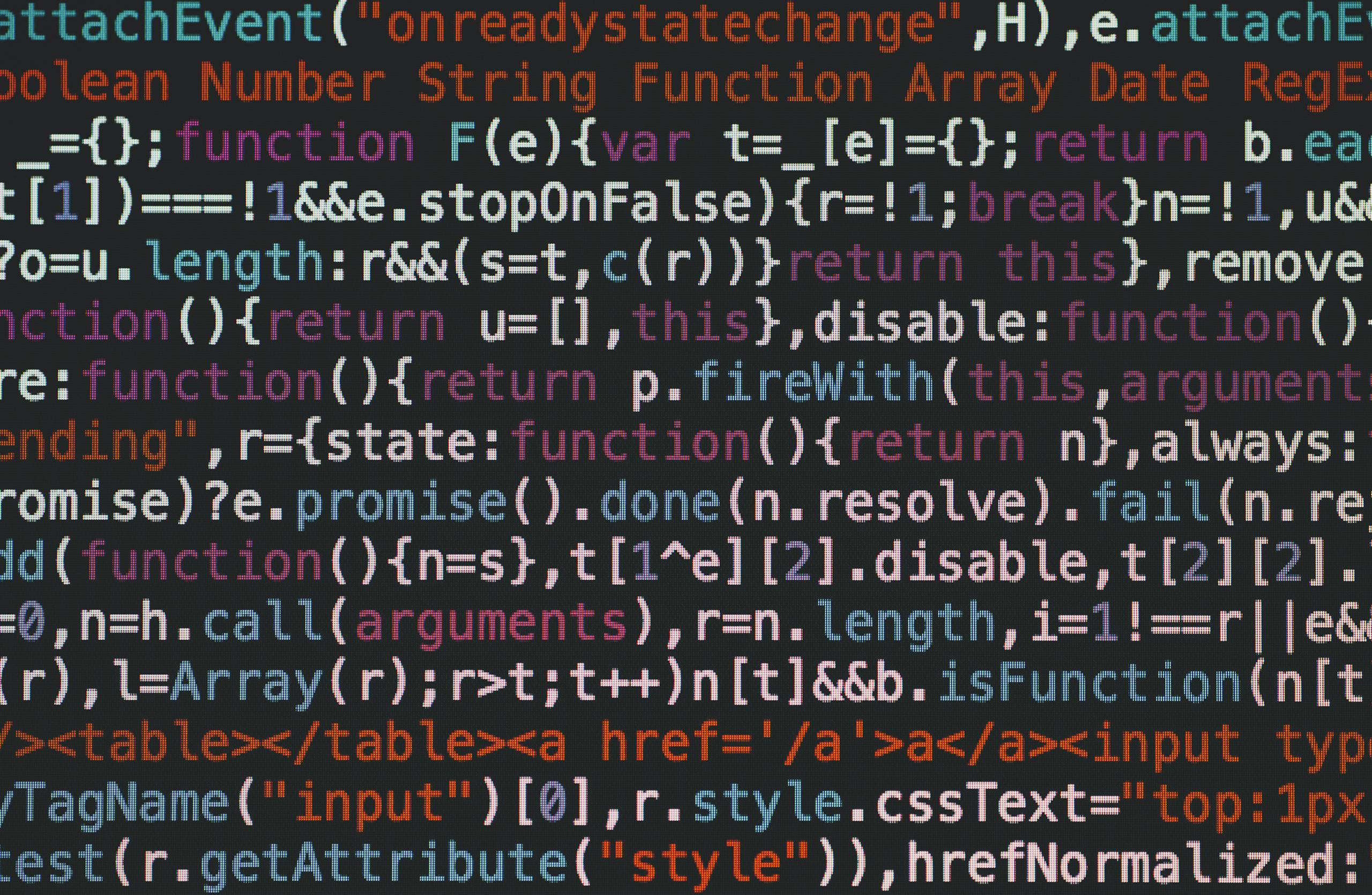 DainikShiksha.com.bd Close-up of colorful coding text on a dark computer screen, representing software development.