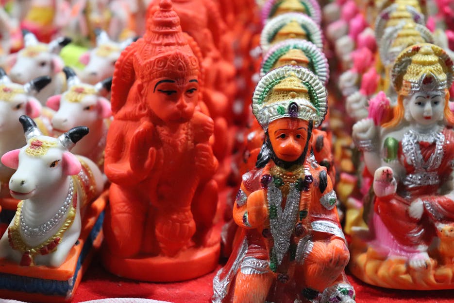Hanuman Dham Colorful figurines of Hindu deities and cows displayed in Rourkela, India market.