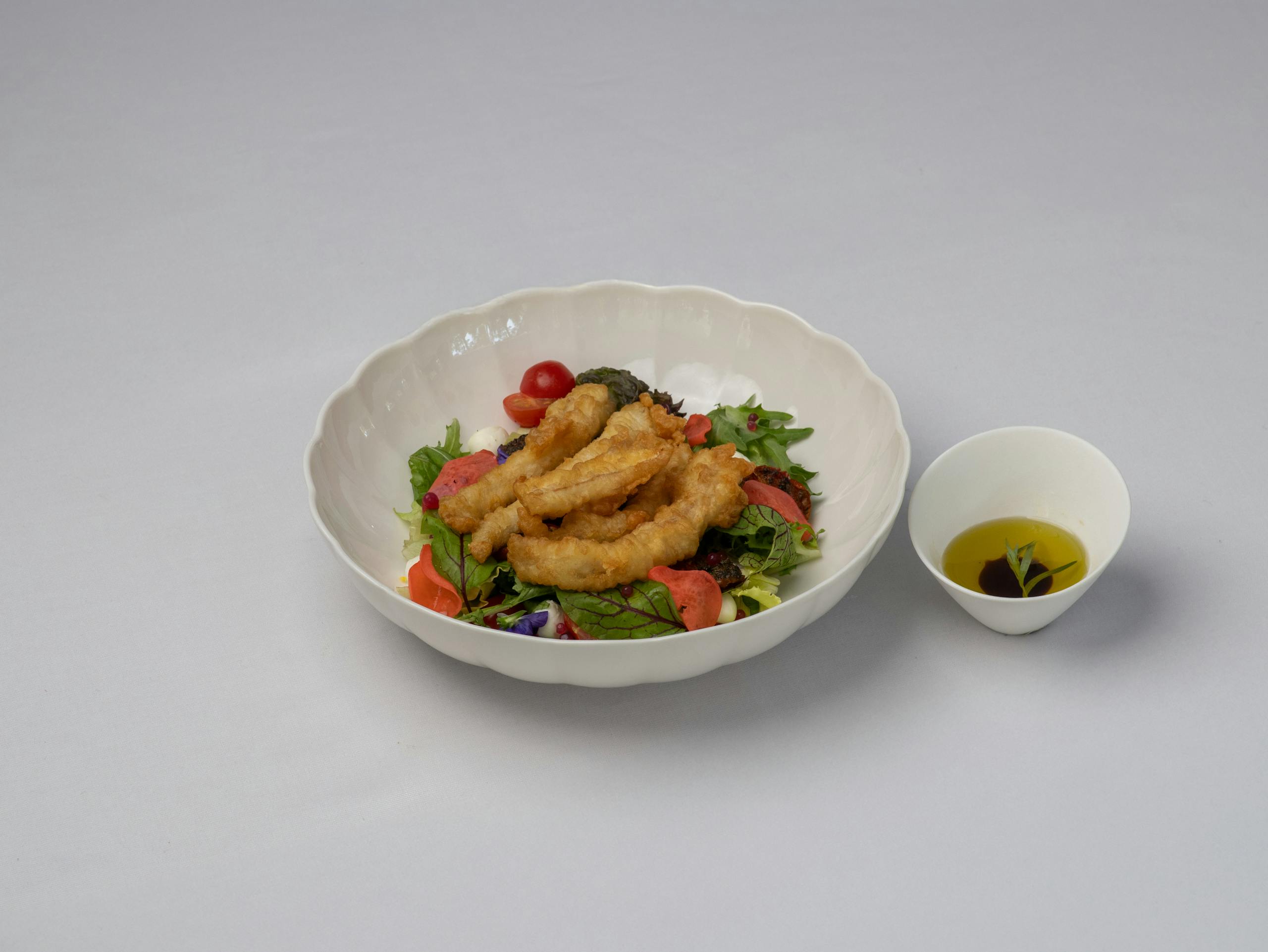 Calamariere Delicious calamari salad with a side of olive oil dressing in Bodrum, Türkiye.