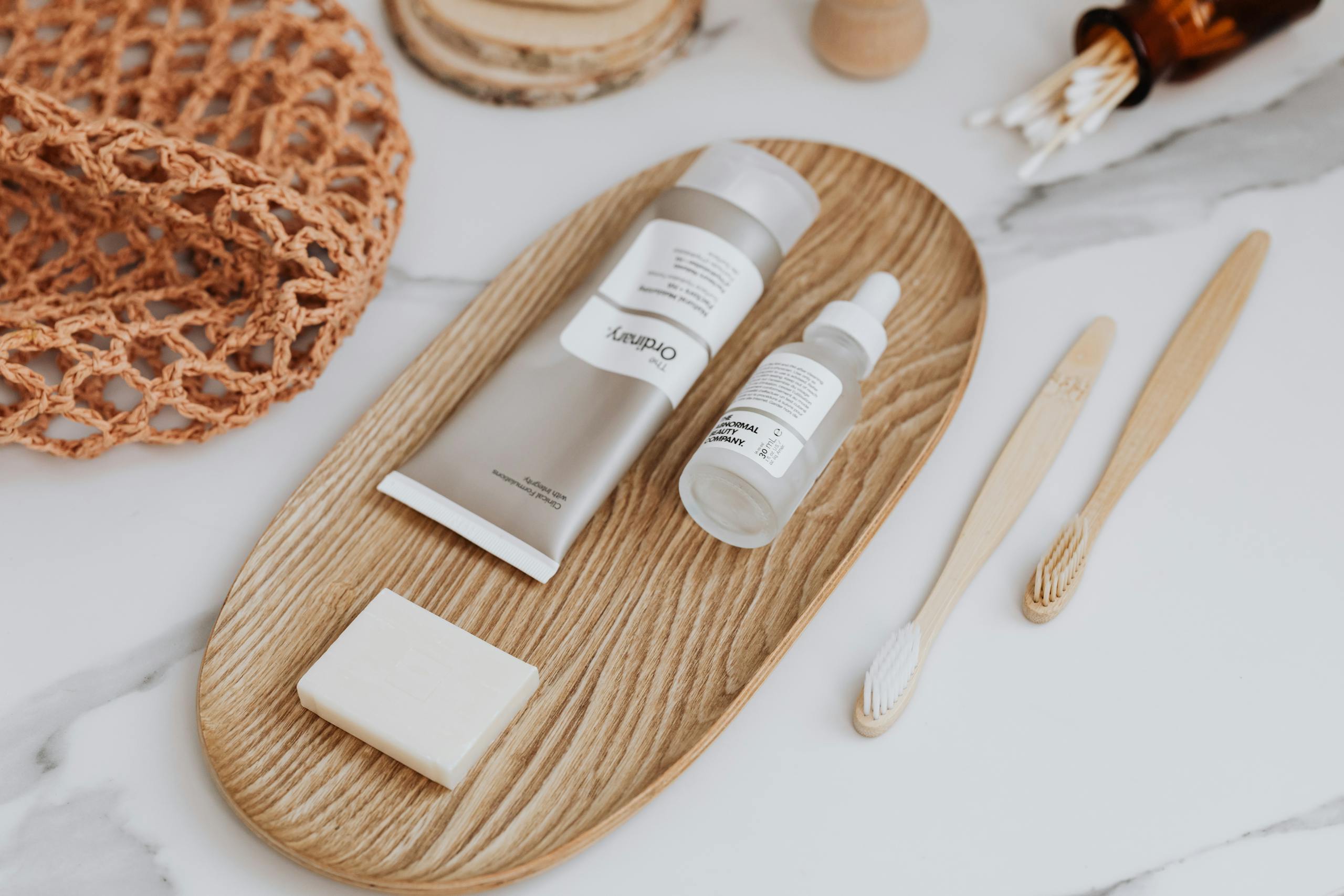 Well Health Tips in Hindi WellHealthOrganic Flat lay of zero waste bathroom essentials including bamboo toothbrushes and skincare products.