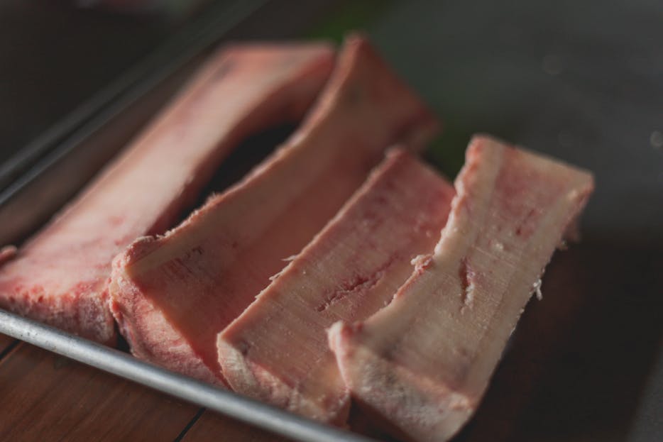 Gastroshiza High-quality close-up image of raw beef bone marrow slices on a tray, perfect for cooking concepts.