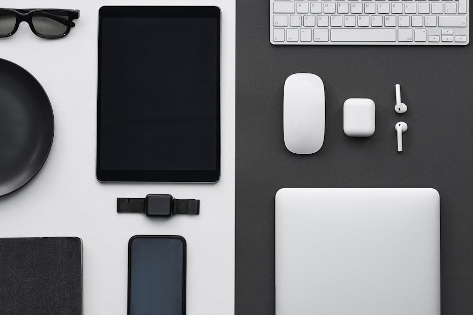 impupdates Stylish flatlay of modern tech gadgets including tablet, smartphone, smartwatch, and accessories.