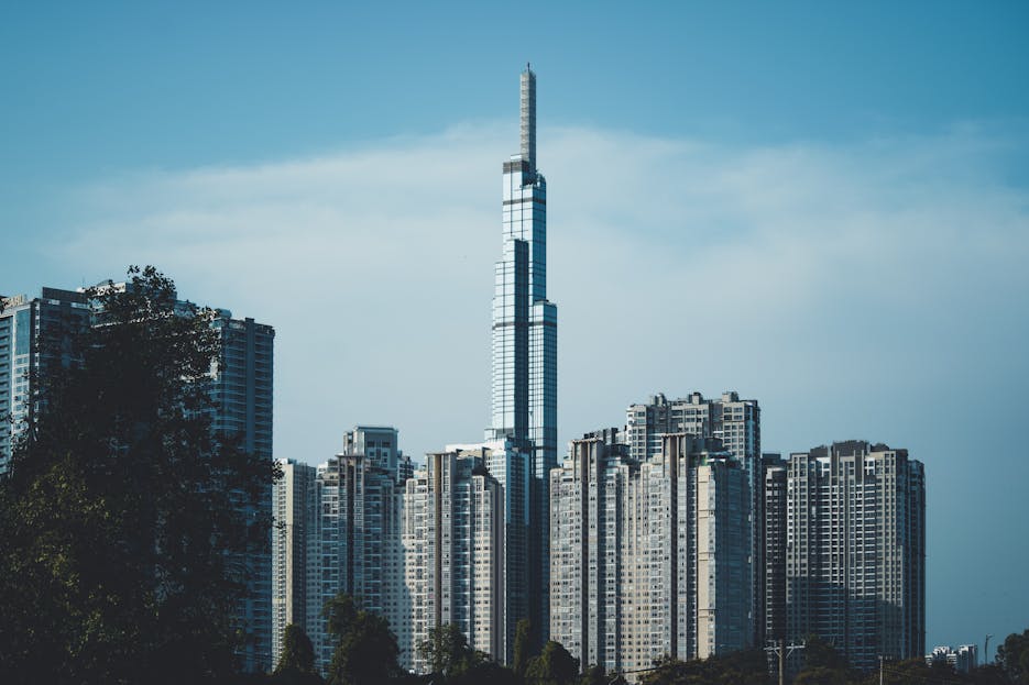 Snowhiter Check Whether 61479 Is Divisible by 81 View of Landmark 81 surrounded by skyscrapers under clear skies in urban Vietnam.