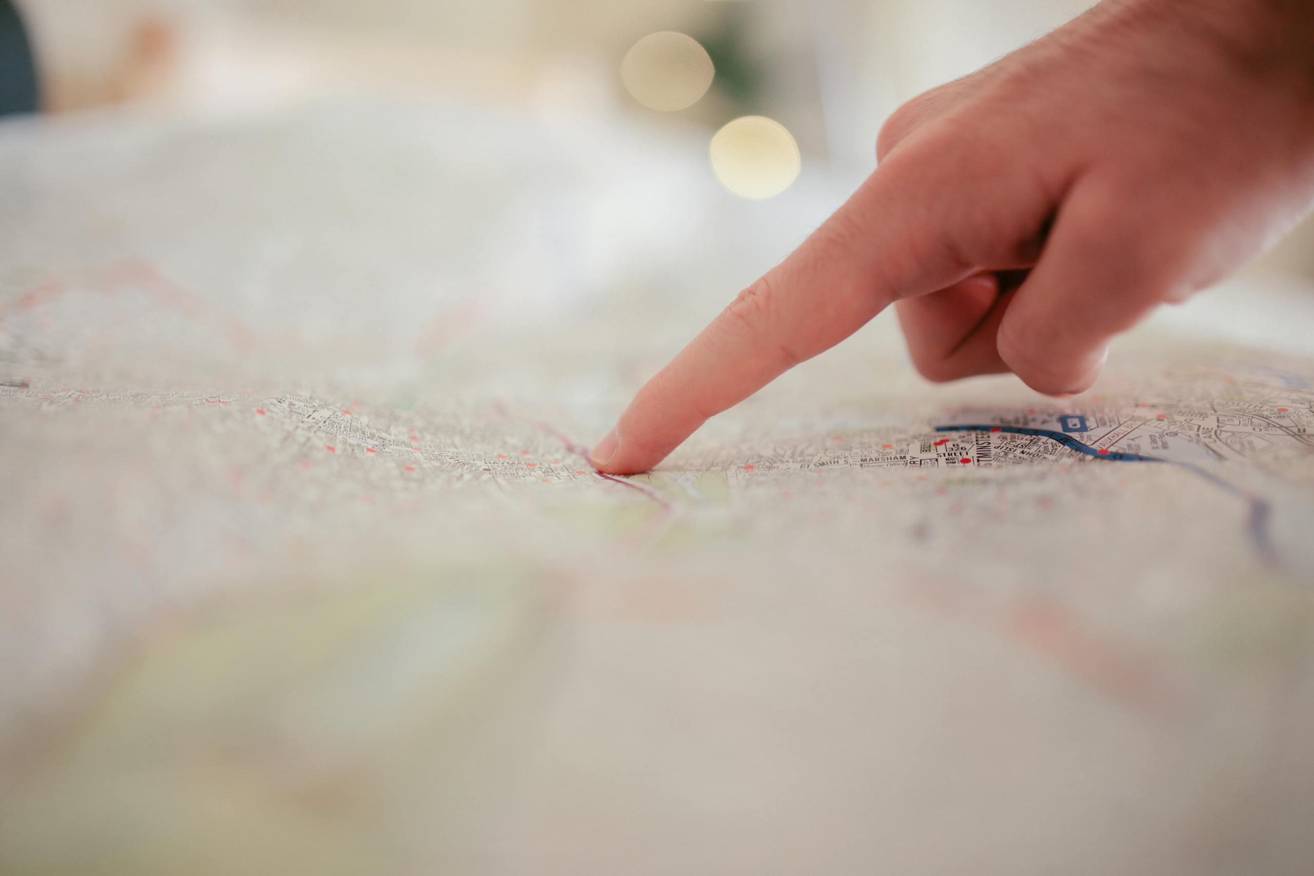 630 Area Codec A hand pointing at a city map, highlighting direction and navigation planning.