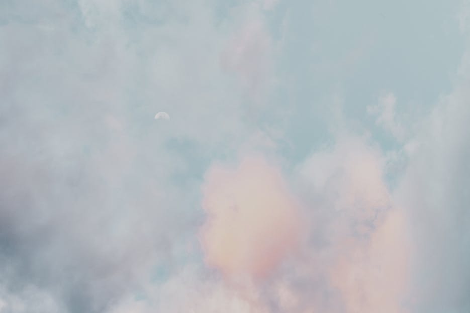 Redeepseek A serene scene of pastel clouds and a subtle moon in a calming sky, perfect for a peaceful backdrop.