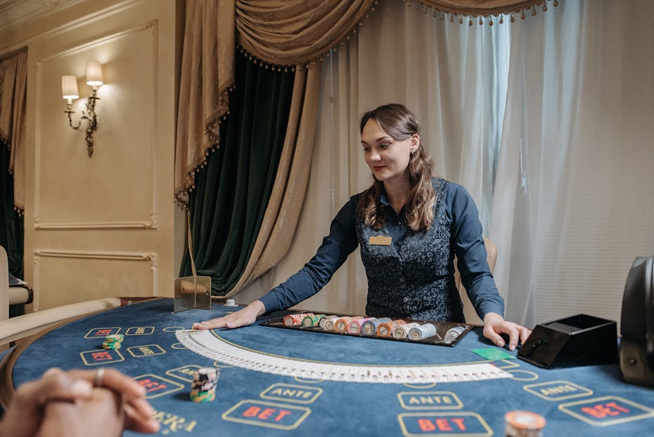 norsk casino www ribitup com Casino dealer managing cards and chips in an elegant gambling setting.