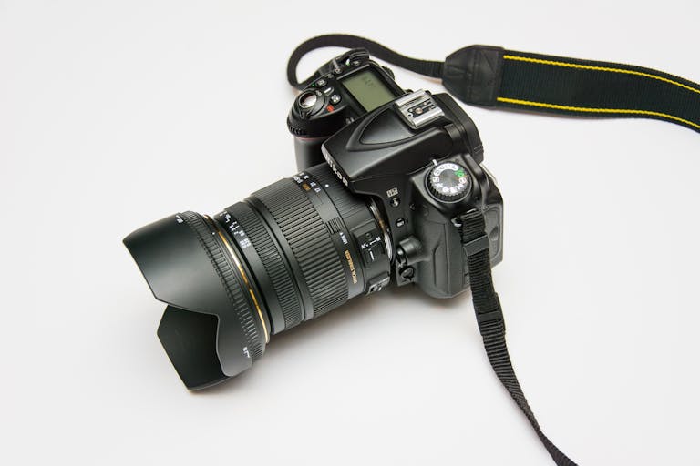 lufanest Close-up of a DSLR camera with a lens and strap, ideal for photography equipment themes.