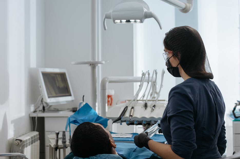 Dental Software News Today Dentist conducting a thorough checkup on a patient in a modern dental clinic setting.