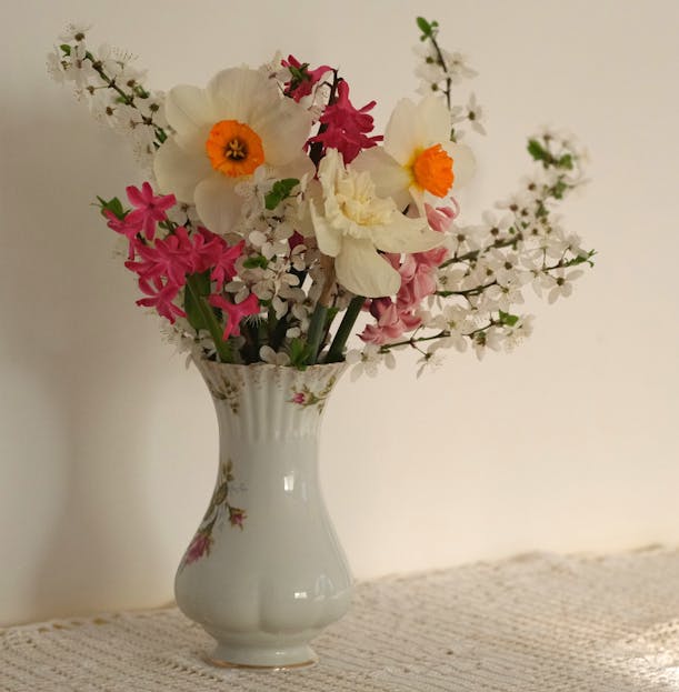 Shop Spring Vase Fresh spring bouquet with daffodils and cherry blossoms in a porcelain vase.