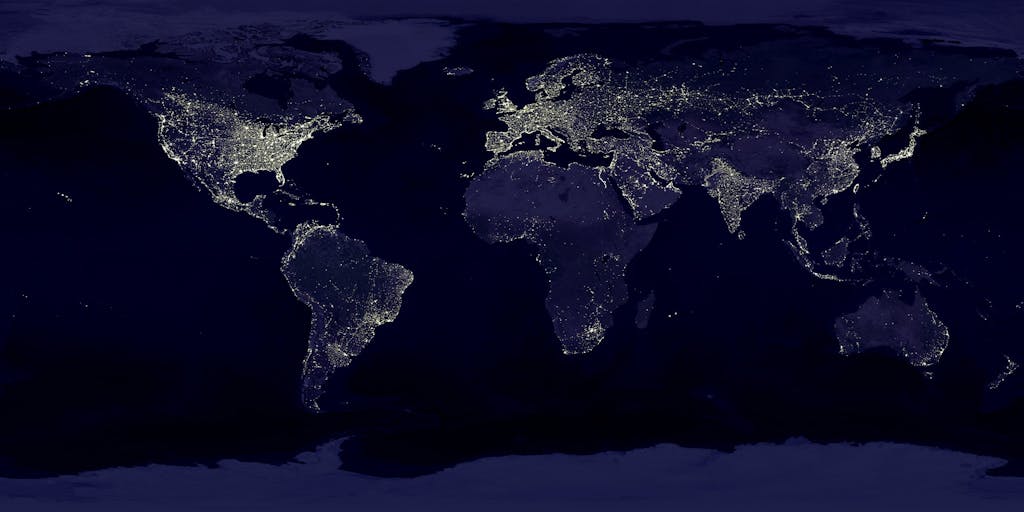 TheGlobeAndMail Satellite view of Earth at night with illuminated cities across continents.