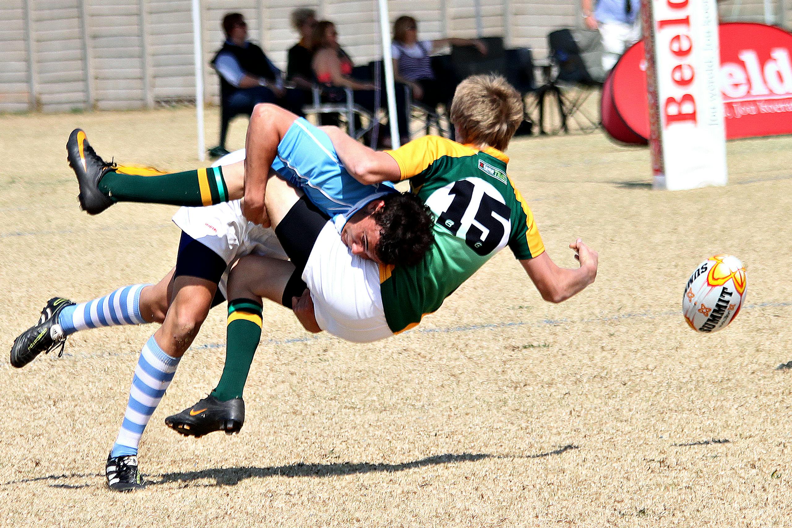 Miami Dolphins vs Texans Match Player Stats Two rugby players collide mid-air in an action-packed outdoor rugby match.