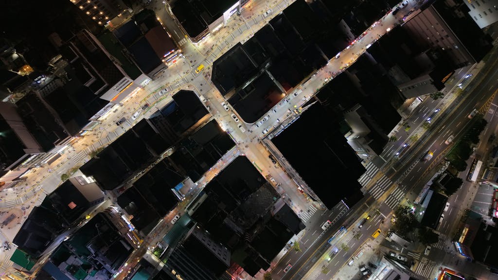 The Vzusa A captivating aerial night view of bustling city streets in Busan, South Korea.