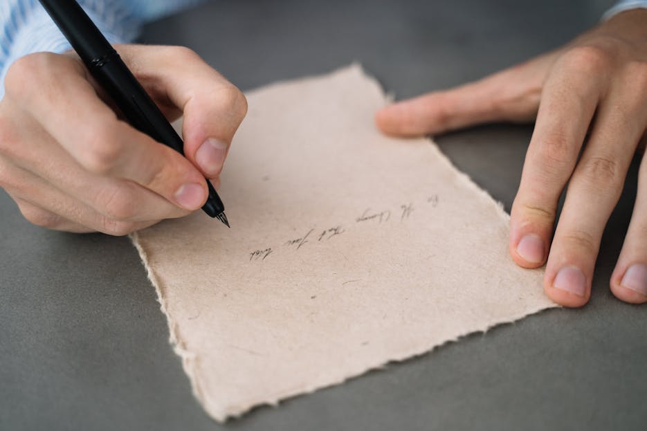 Twastia Com Write for Us Hands writing in calligraphy on rustic parchment paper. Perfect for vintage or artistic themes.