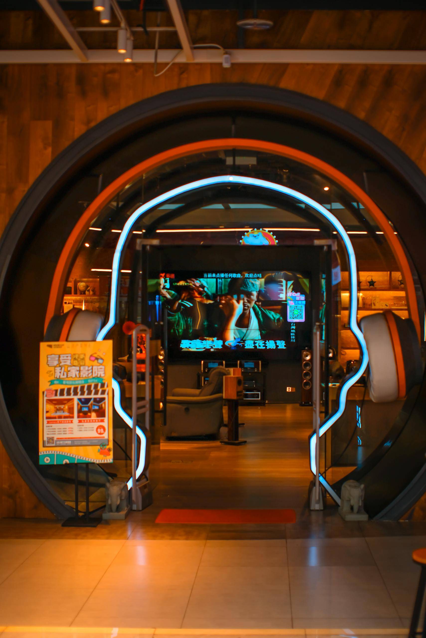Decreto Supremo 160 Stylish store entrance featuring a headphone design with bright neon lights and electronics in the background.