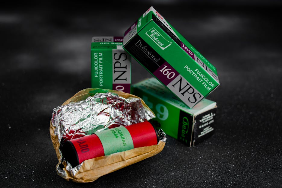 Decreto Supremo 160 Vintage Fujicolor portrait film rolls and packaging on a textured black surface.