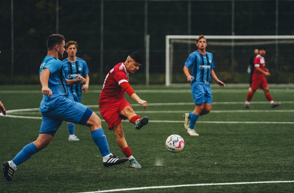 Streameast Soccer Action-packed soccer match showcasing teams in blue and red uniforms on a grass field.