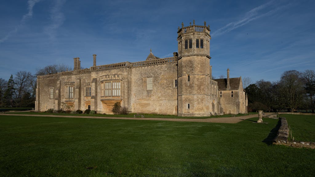Pabington Historic Lacock Abbey in England bathed in winter sunlight, showcasing Gothic architecture.