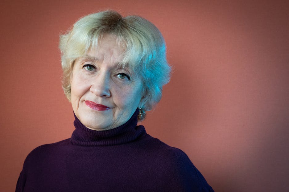 Jan Ashley Portrait of a senior woman with elegant expression, captured in a studio setting.